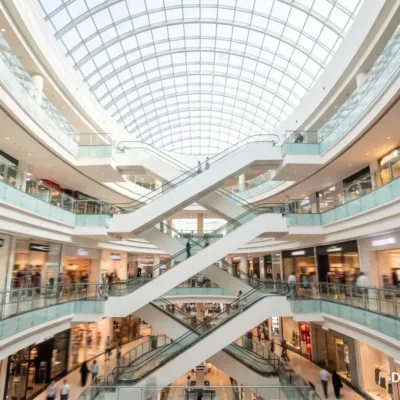 Multi-level Dubai shopping mall atrium with escalators under a glass roof